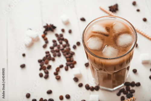 Glass of tasty iced coffee on table