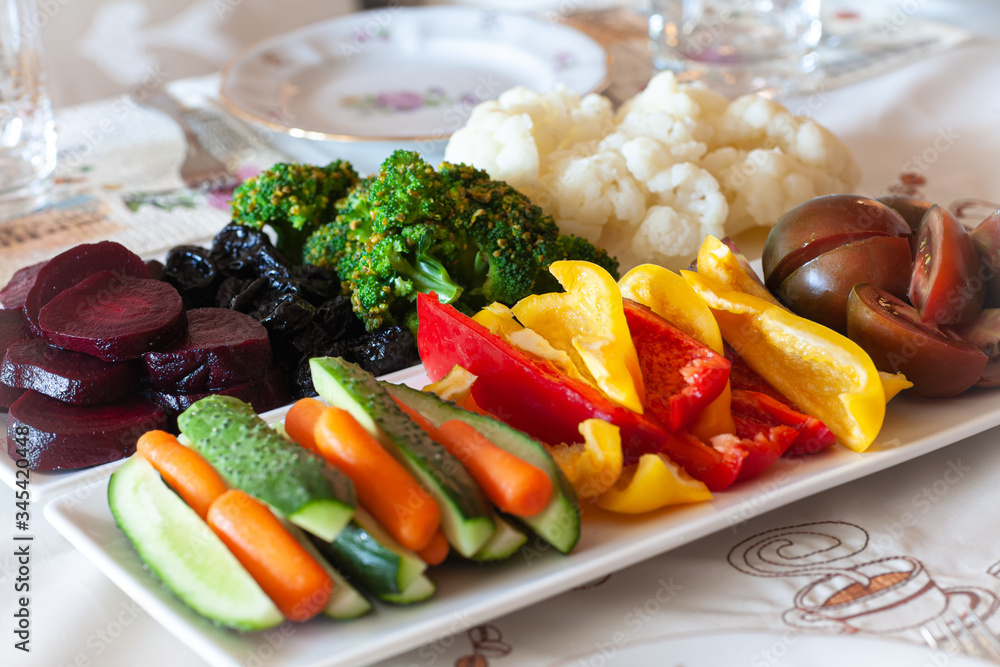 Soft focus. Dinner table. On a plate is a set of vegetables. Soft focus. Dinner table. On a plate is a set of vegetables.