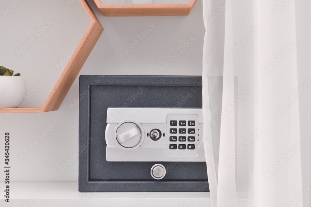 Modern safe on shelf in room Modern safe on shelf in room
