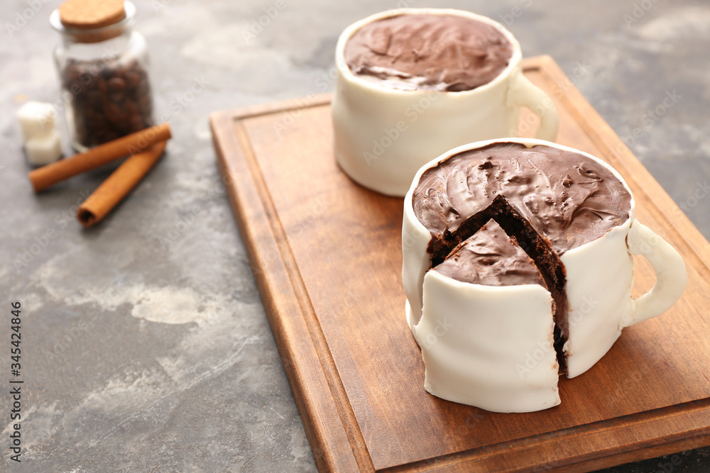Chocolate cakes in shape of coffee cups on grunge background Chocolate cakes in shape of coffee cups on grunge background