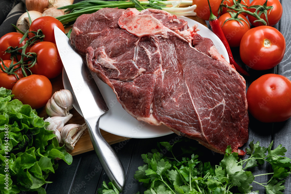 A juicy piece of fresh meat. Meat and vegetables. Cooking meat. A chef's knife. Balanced diet. Red meat.