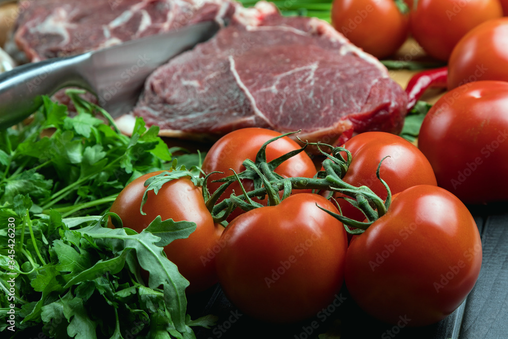 A juicy piece of fresh meat. Meat and vegetables. Cooking meat. A chef's knife. Balanced diet. Red meat. A juicy piece of fresh meat. Meat and vegetables. Cooking meat. A chef's knife. Balanced diet. Red meat.