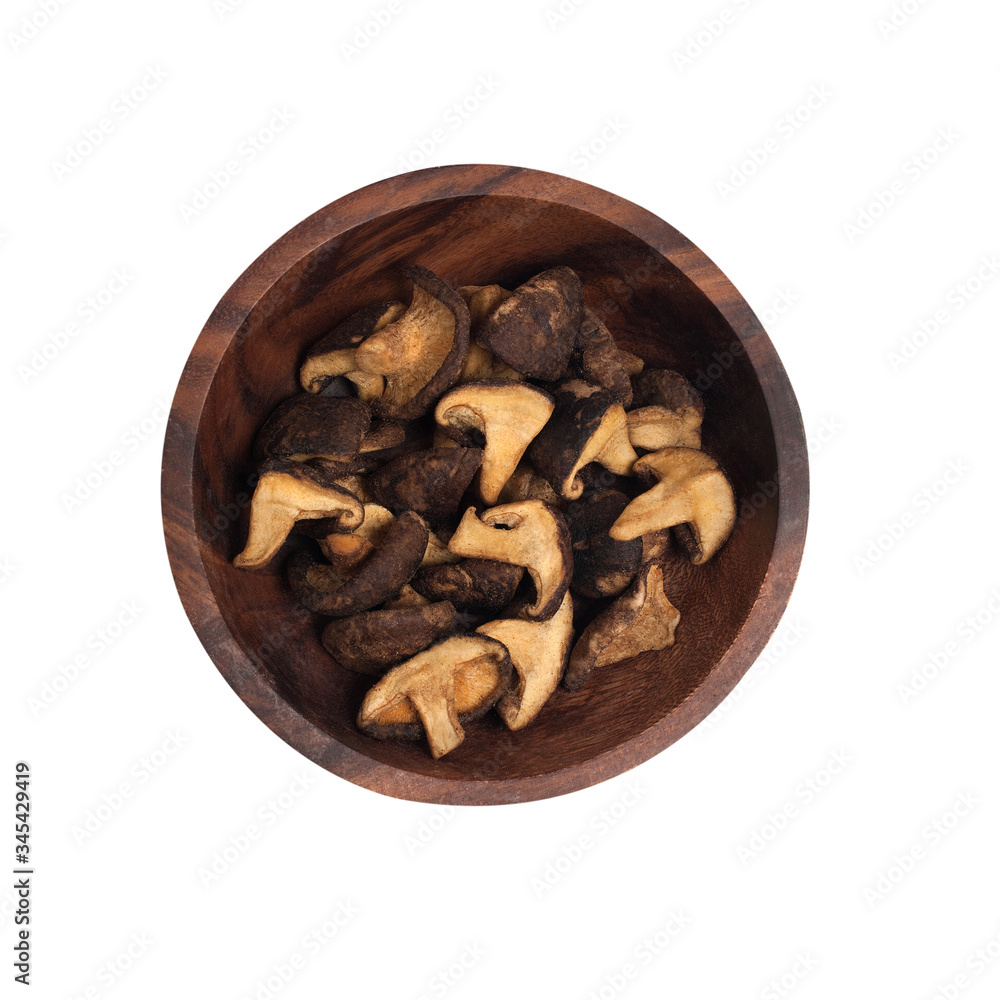 dried shiitake mushrooms in a brown wooden plate. dried shiitake mushrooms in a brown wooden plate.