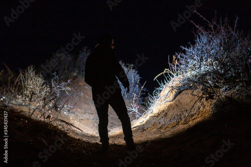 Man exploring unique landscape with flashlight