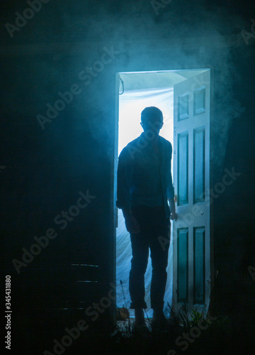 mysterious man looking through open door