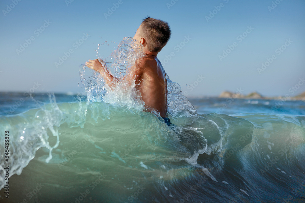 a child jumps in the splash water a child jumps in the splash water