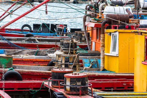 small colored fishing boats moored in the harbor