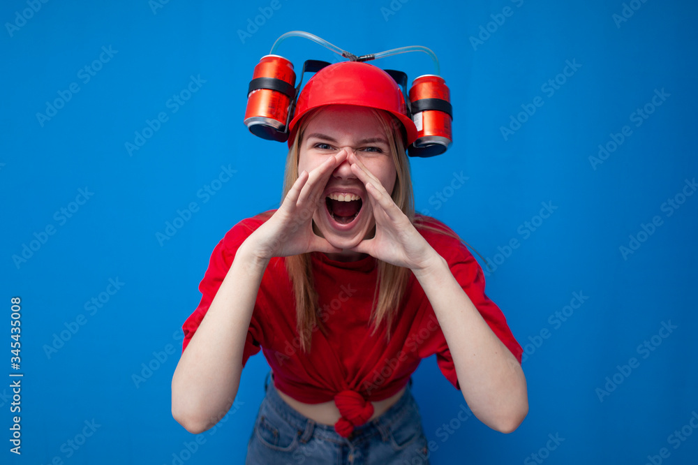 young crazy fan aggressively screaming against a blue background, a cheerleader is rooting for the team young crazy fan aggressively screaming against a blue background, a cheerleader is rooting for the team