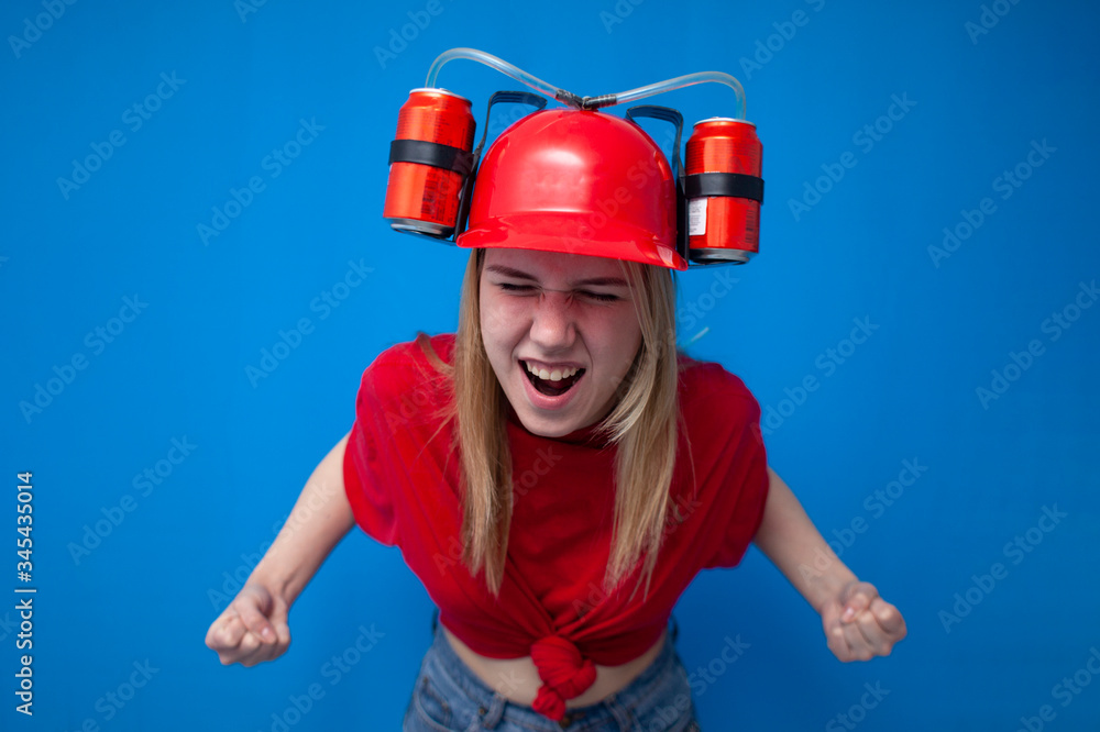 funny girl a fan in a red uniform and a beer hat watches the game and enjoy the victory, the winner screams and holds hands in fists funny girl a fan in a red uniform and a beer hat watches the game and enjoy the victory, the winner screams and holds hands in fists