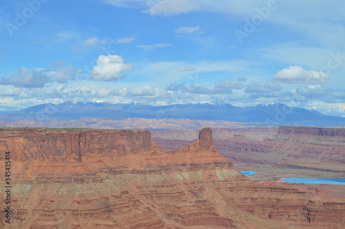 Rock formations at Dead Horse Point with Potash Ponds and the snowcapped La Sal Mountain range in the distance, Utah