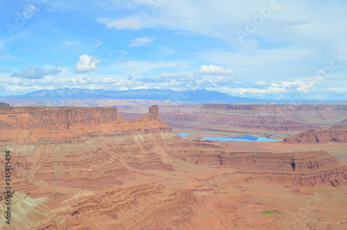 Rock formations at Dead Horse Point with Potash Ponds and the snowcapped La Sal Mountain range in the distance, Utah