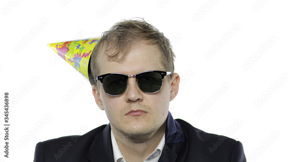 Drank sleepy young businessman with hangover in festive cap and sunglasses Drank sleepy young businessman with hangover in festive cap and sunglasses