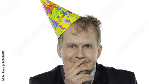 Drank sleepy young businessman with hangover in festive cap smiling photo