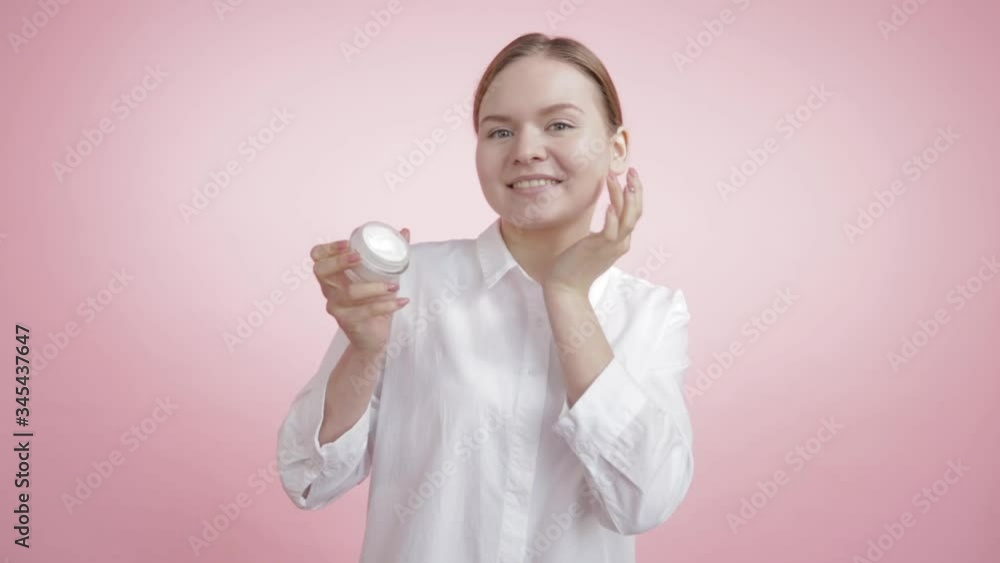 Natural white moisturizer on the cheek of a beautiful girl. Natural white moisturizer on the cheek of a beautiful girl.