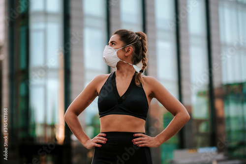girl does sports with a mask on the street during the confinement of coronavirus