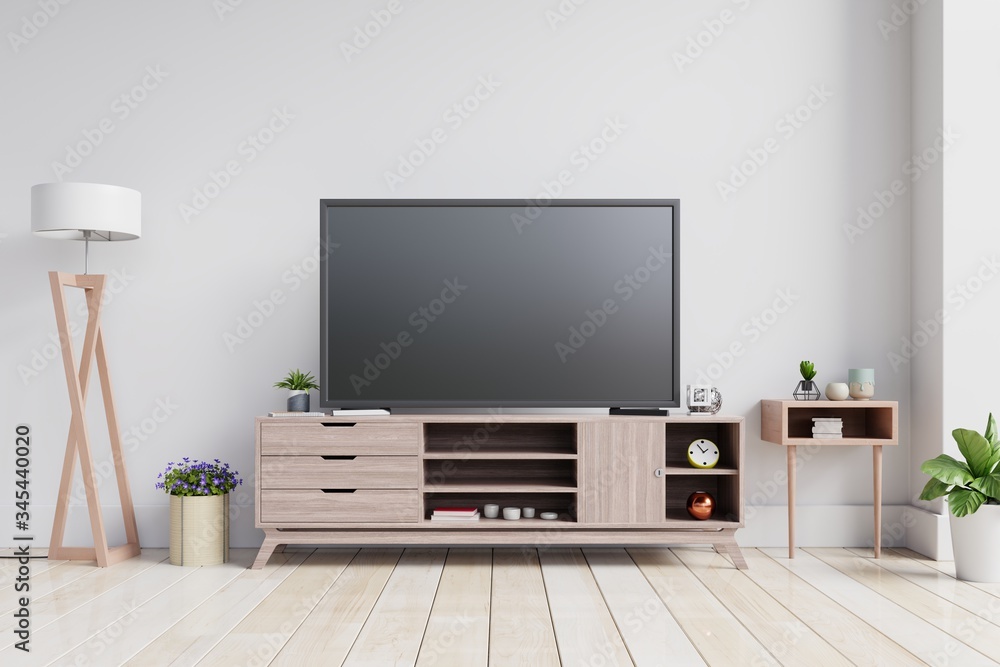 TV on the cabinet in modern living room on white wall background. TV on the cabinet in modern living room on white wall background.