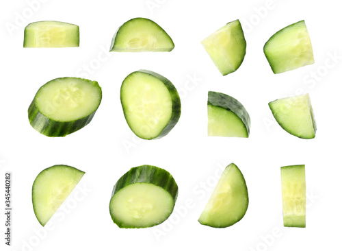 Set of fresh cucumber slices on white background