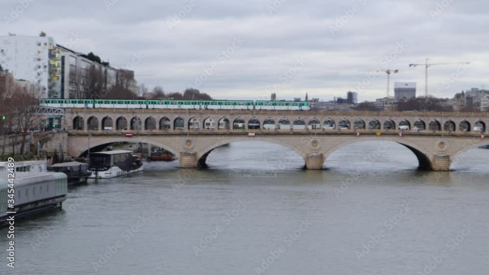 Bercy bridge metro line tracking during overcast day with french minister of finances Bercy bridge metro line tracking during overcast day with french minister of finances