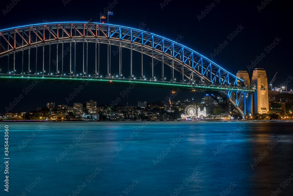 Fototapeta premium Sydney Harbour Bridge illuminated in blue light at night time