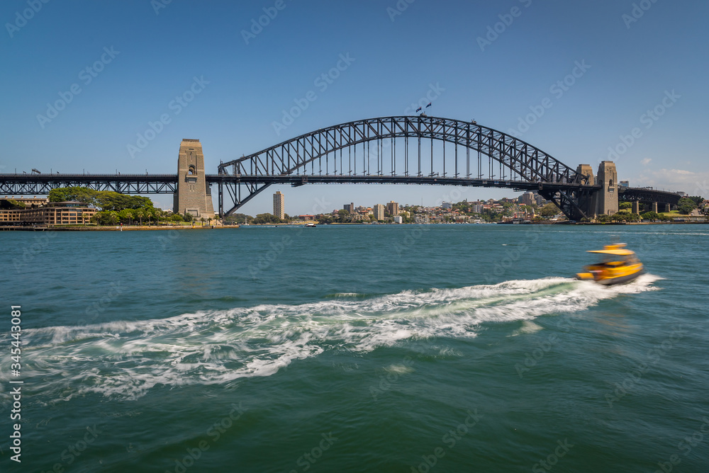 Boats at Sydney Harbor Bridge on a sunny day at Circular Quay, Australia