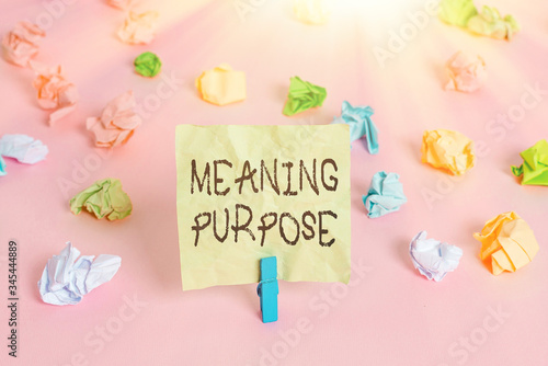 Conceptual hand writing showing Meaning Purpose. Concept meaning The reason for which something is done or created and exists Colored crumpled papers empty reminder pink floor clothespin photo