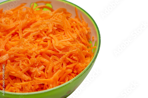 Shredded fresh carrots close-up on a white background.