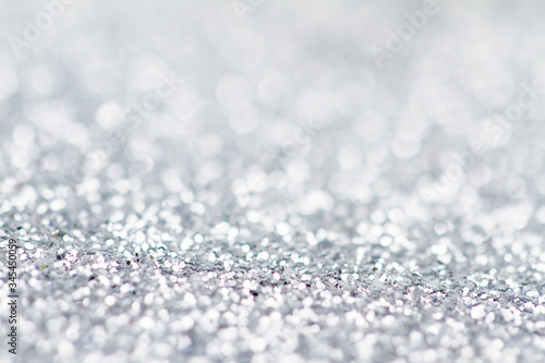 Silver glitter bokeh background with shallow depth of field