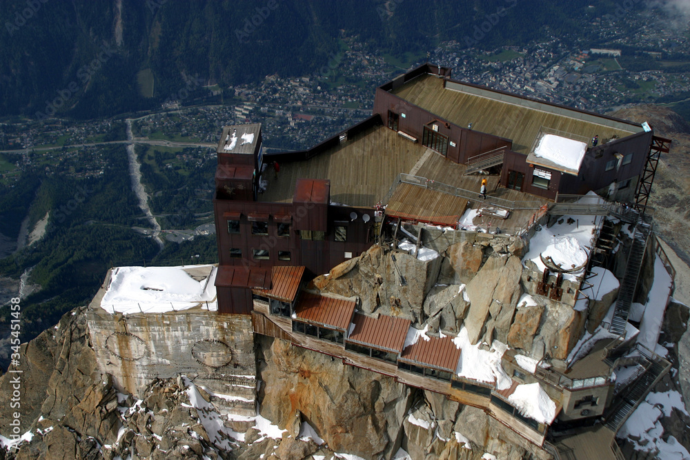 Top of the Mount Aiguille Du Midi and Chamonix Village in French Alps, France. Top of the Mount Aiguille Du Midi and Chamonix Village in French Alps, France.