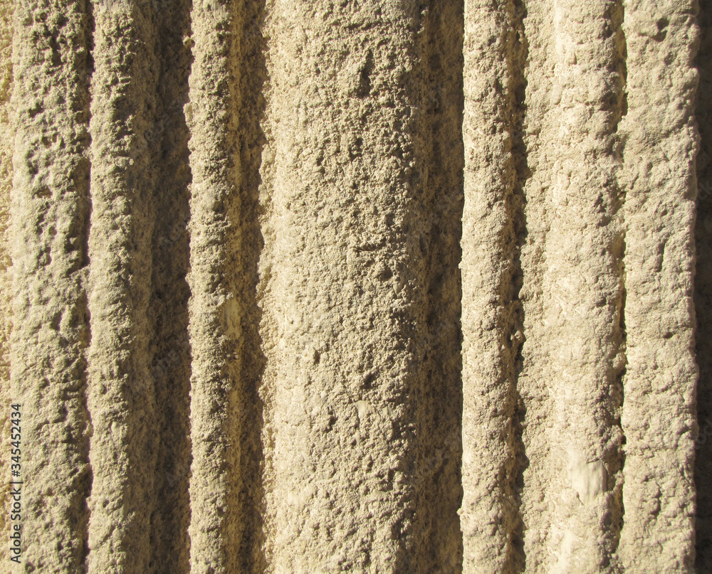 Plastered and painted wall textured background. Vertical molding on