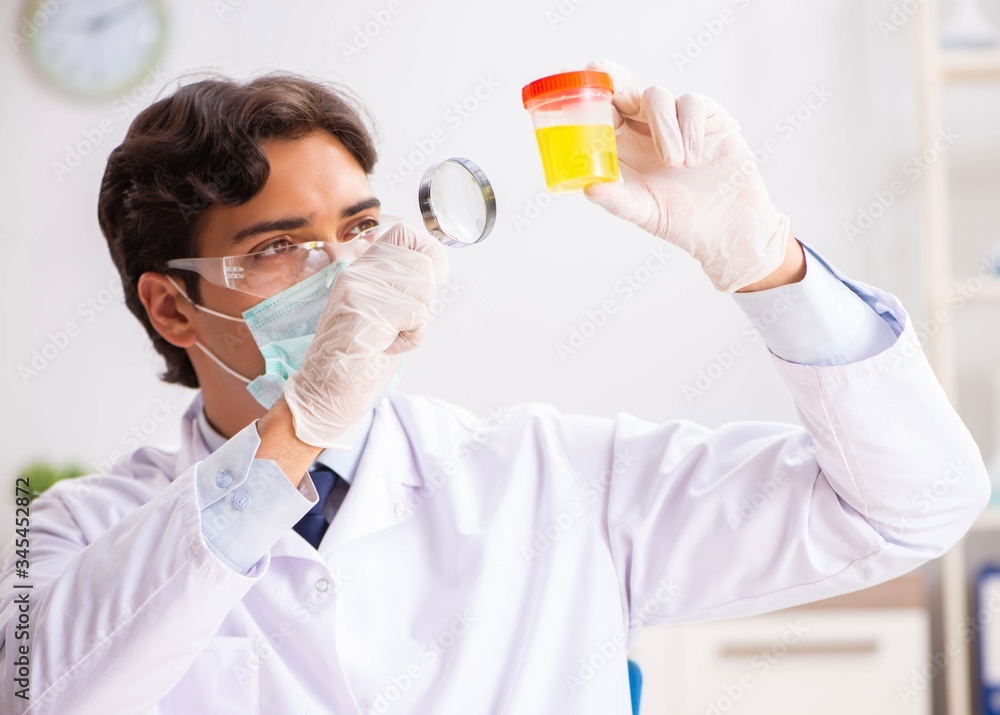 Young handsome chemist working in the lab Young handsome chemist working in the lab