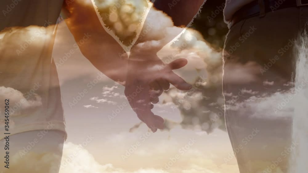 Animation of a Christian cross over a couple holding hands Animation of a Christian cross over a couple holding hands