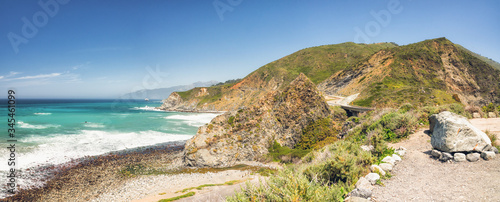 Big Sur, Monterey County, California. Panoramic view Pacific Ocean, cliffs, and native plants on the beach. Panoramic view