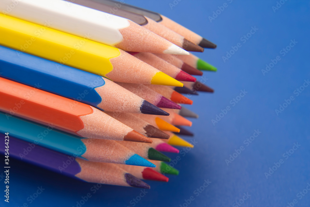 set of color pencils on a blue background. drawing tools. a palette in creativity set of color pencils on a blue background. drawing tools. a palette in creativity