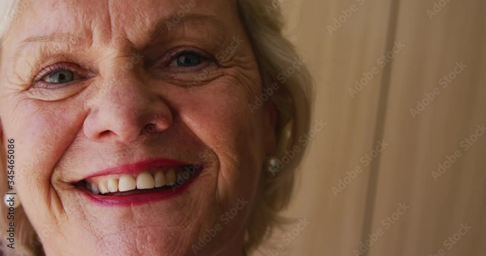 Senior woman in social distancing smiling at camera Senior woman in social distancing smiling at camera