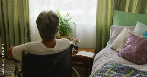 Senior woman in social distancing in her room of retirement house photo