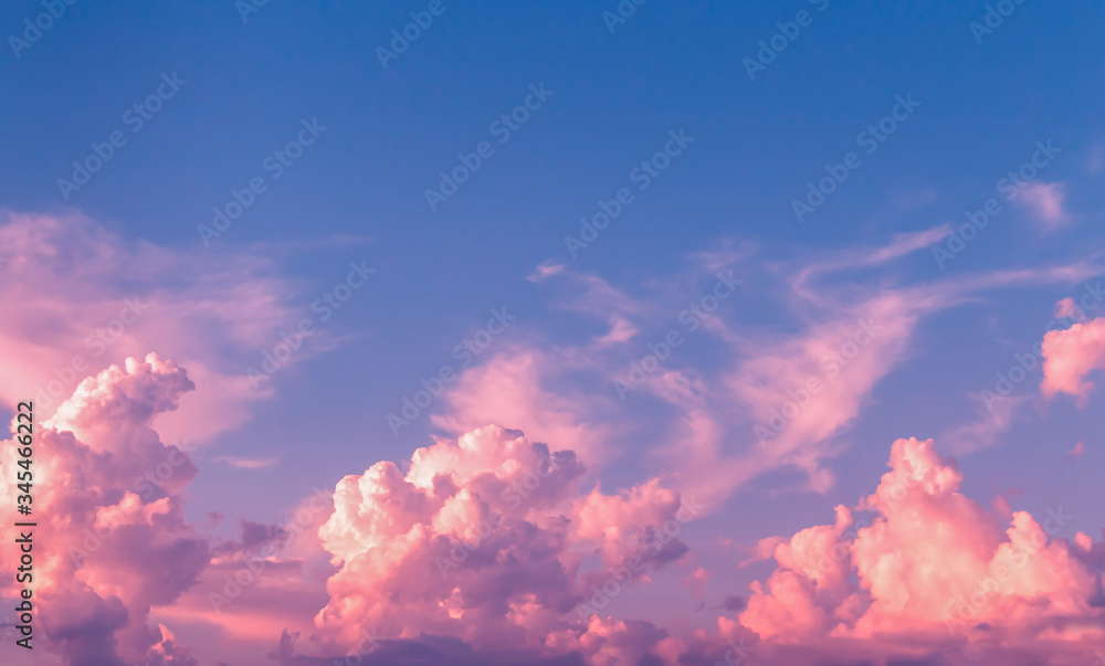 Pink and purple cloudscape in dim blue sky