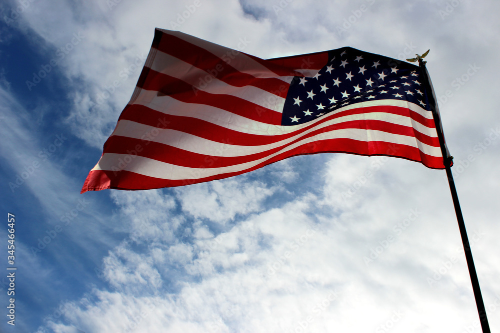 USA flag on a background of bare sky. Independence Day and USA. USA flag on a background of bare sky. Independence Day and USA.