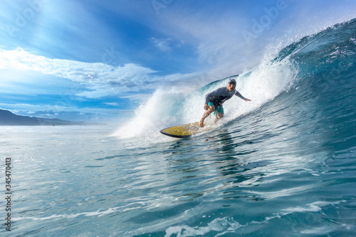 surfer riding on big waves on the Indian Ocean island of Mauritius photo