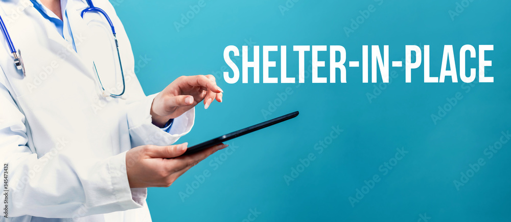 Shelter in place coronavirus theme with a doctor using a tablet computer Shelter in place coronavirus theme with a doctor using a tablet computer
