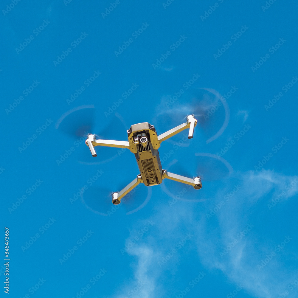 Drone hovering in the blue sky Drone hovering in the blue sky