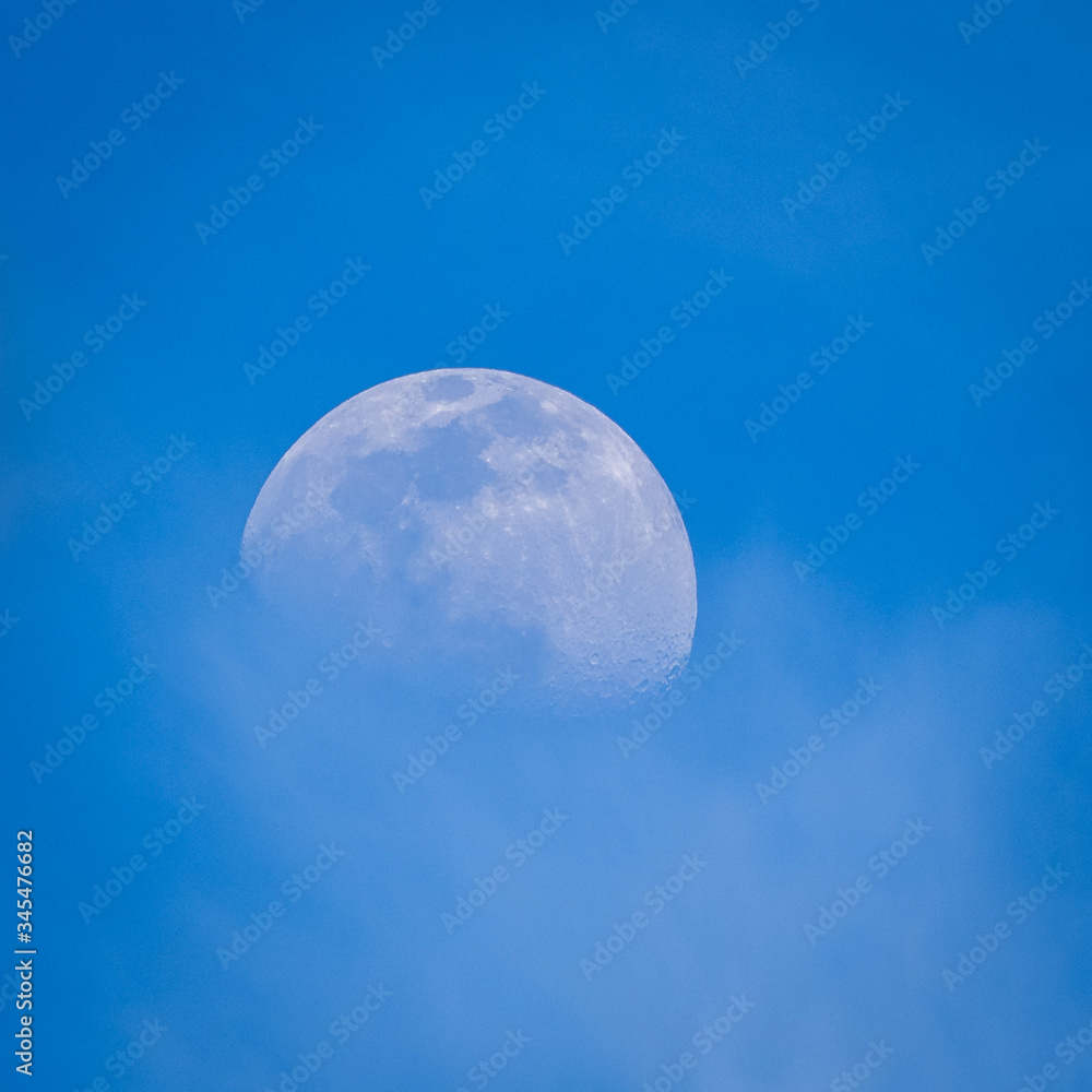 Half moon in the blue sky at late afternoon Half moon in the blue sky at late afternoon