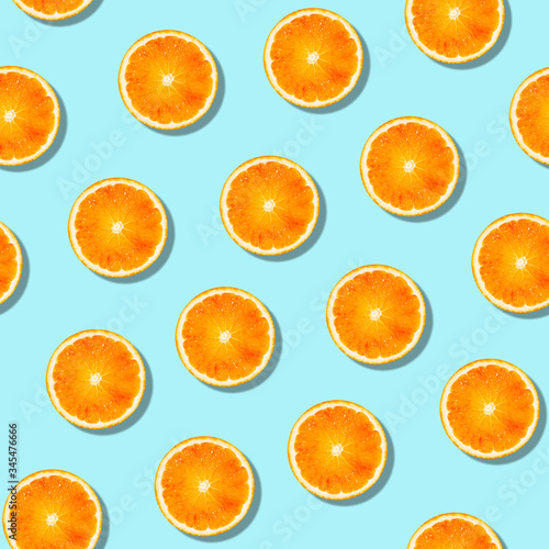 Seamless orange fruit pattern on blue background.