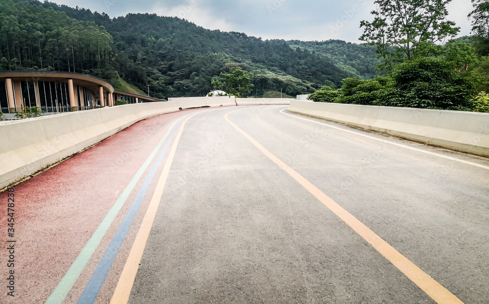 Background material of asphalt road in natural forest, road of automobile advertisement. Background material of asphalt road in natural forest, road of automobile advertisement.