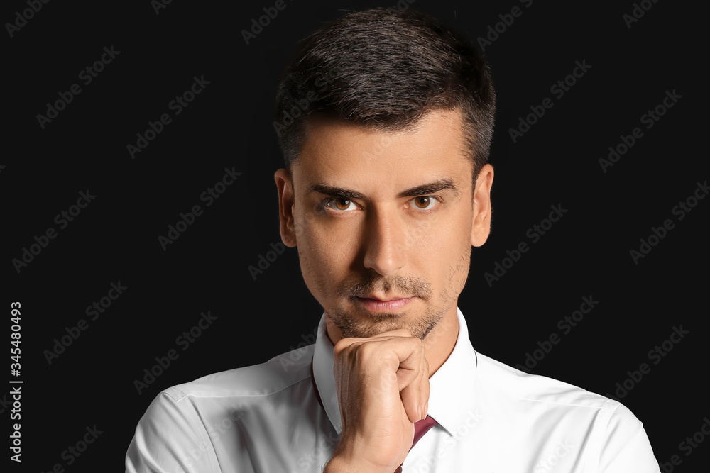 Portrait of handsome businessman on dark background Portrait of handsome businessman on dark background