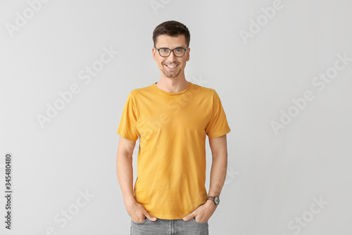Man in stylish t-shirt on grey background © Pixel-Shot