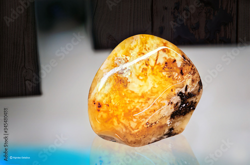 Beautiful piece of amber on a glass shelf photo