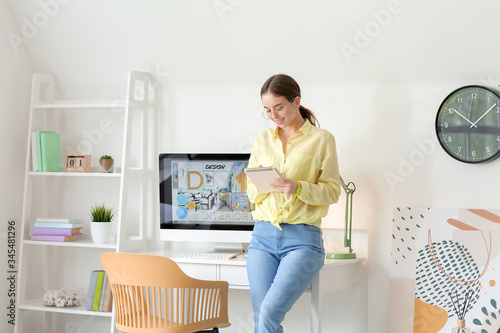Young female designer working at home