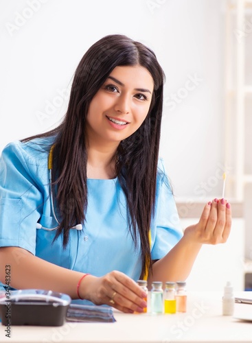 Young beautiful female doctor working in the clinic