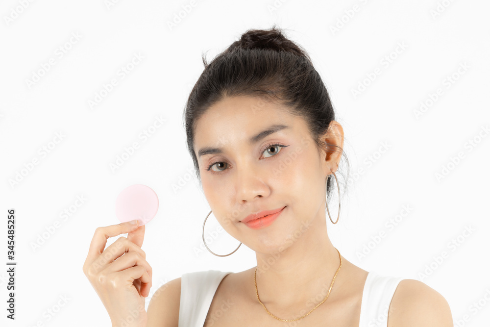 Pretty beauty young Asian woman with cotton pad over white isolated background. Healthy skin and cosmetics concept. Pretty beauty young Asian woman with cotton pad over white isolated background. Healthy skin and cosmetics concept.