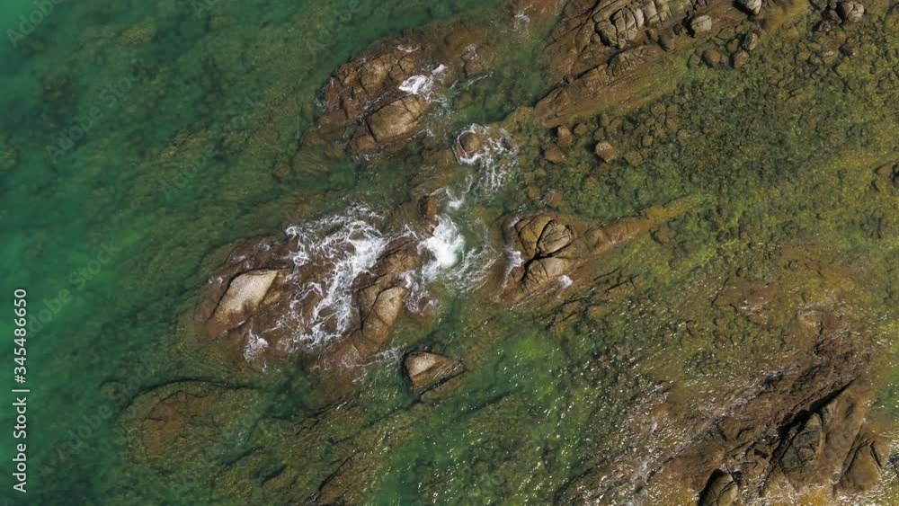 Clear waves - Rocky shoreline and turquoise clear Water - Natai, Thailand - Top view Clear waves - Rocky shoreline and turquoise clear Water - Natai, Thailand - Top view